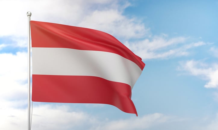 Austrian flag waving in the blue sky