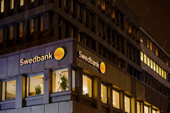 Swedbank logo on a snowy night on the building facade